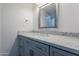 Bathroom vanity features a quartz countertop and a decorative framed mirror at 10532 N 79Th St, Scottsdale, AZ 85258