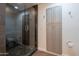 Bathroom includes a tiled walk-in shower with glass door and built-in storage at 10532 N 79Th St, Scottsdale, AZ 85258