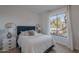 Cozy bedroom featuring a comfortable bed, a large window, and stylish bedside tables with lamps at 10532 N 79Th St, Scottsdale, AZ 85258