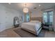 This well-lit bedroom features an upholstered bed frame, and serene, neutral tones at 10532 N 79Th St, Scottsdale, AZ 85258