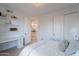Bright bedroom with white walls, closet, light hardwood floors, and built in desk and shelves at 10532 N 79Th St, Scottsdale, AZ 85258