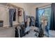 Walk-in closet featuring an organization system, exercise bike, natural light, and neutral colors at 10532 N 79Th St, Scottsdale, AZ 85258