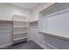 Walk-in closet with built-in shelving and wooden clothes rods at 10532 N 79Th St, Scottsdale, AZ 85258
