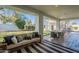 A covered patio featuring a stone floor, neutral colored couch, and a large dining table at 10532 N 79Th St, Scottsdale, AZ 85258