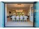 Bright dining room features a modern chandelier and seamless indoor-outdoor living through sliding glass doors at 10532 N 79Th St, Scottsdale, AZ 85258