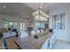Elegant dining area with modern lighting, a long dining table, and views of the living room and kitchen at 10532 N 79Th St, Scottsdale, AZ 85258