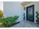 Inviting front entrance with a decorative wrought iron door, manicured greenery, and stone pavers at 10532 N 79Th St, Scottsdale, AZ 85258