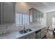 Bright kitchen with stainless appliances, gray cabinetry, and white quartz countertops at 10532 N 79Th St, Scottsdale, AZ 85258