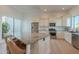 Well-lit kitchen featuring white cabinets, stainless steel appliances, and a granite island with seating at 10532 N 79Th St, Scottsdale, AZ 85258