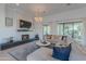 Open living room with a fireplace, large sectional sofa, and access to the outdoor space at 10532 N 79Th St, Scottsdale, AZ 85258