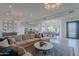 Spacious living room featuring a large sectional sofa, a view of the kitchen, and lots of natural light at 10532 N 79Th St, Scottsdale, AZ 85258