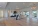 Bright living room featuring a fireplace, large windows, and access to the outdoor patio at 10532 N 79Th St, Scottsdale, AZ 85258
