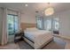 Bright main bedroom with a comfortable bed, natural light, and French doors to the patio at 10532 N 79Th St, Scottsdale, AZ 85258