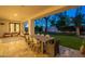 Covered patio with outdoor dining, lounge seating, and a view of the landscaped backyard at 10532 N 79Th St, Scottsdale, AZ 85258