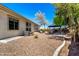The backyard features a gazebo, desert landscaping, and easy access to the home at 1096 E Lodgepole Dr, Gilbert, AZ 85298