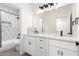 Stylish bathroom featuring white cabinetry, modern hardware, and decorative geometric wall tile at 1096 E Lodgepole Dr, Gilbert, AZ 85298