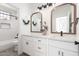 Bathroom featuring dual sinks, framed mirrors, white cabinets, and a separate shower and toilet room at 1096 E Lodgepole Dr, Gilbert, AZ 85298