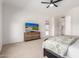 Bedroom with large dresser, ceiling fan, and view through sliding glass door on the home displayed on television at 1096 E Lodgepole Dr, Gilbert, AZ 85298