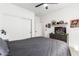 Bedroom with a gray bed, dresser, sliding closet, and modern decorations on a shelf at 1096 E Lodgepole Dr, Gilbert, AZ 85298