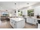 Open-concept kitchen with an island, stainless steel appliances, and an adjacent living area, ideal for modern living at 1096 E Lodgepole Dr, Gilbert, AZ 85298