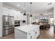 Beautiful kitchen with stainless steel appliances, white cabinets, a large island, and an open view of the living area at 1096 E Lodgepole Dr, Gilbert, AZ 85298