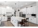 Spacious kitchen with white cabinets, stainless steel appliances, a large center island, and modern pendant lighting at 1096 E Lodgepole Dr, Gilbert, AZ 85298
