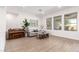 Bright living room featuring neutral walls, wood floors, a piano, and large windows at 1096 E Lodgepole Dr, Gilbert, AZ 85298
