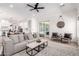 Bright living room with a ceiling fan, plush sofa, stylish rug, and sliding glass doors leading to the outdoor space at 1096 E Lodgepole Dr, Gilbert, AZ 85298