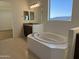 Spacious bathroom with soaking tub, double sink vanity, and tile floors at 10984 N 164Th Dr, Surprise, AZ 85388