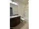 Bathroom featuring a granite countertop, dark cabinets, and shower-tub combination at 10984 N 164Th Dr, Surprise, AZ 85388