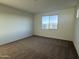 Carpeted bedroom with ample natural light streaming through the window at 10984 N 164Th Dr, Surprise, AZ 85388