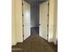 Bedroom entrance with double doors and neutral carpeting at 10984 N 164Th Dr, Surprise, AZ 85388