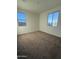 Bedroom featuring carpeted floor and two windows at 10984 N 164Th Dr, Surprise, AZ 85388