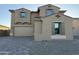 Charming two-story home featuring a large driveway, two-car garage, and neutral color palette at 10984 N 164Th Dr, Surprise, AZ 85388
