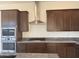 Kitchen featuring stainless steel appliances, gas cooktop, dark cabinets and granite countertops at 10984 N 164Th Dr, Surprise, AZ 85388