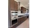 Spacious kitchen featuring stainless steel appliances, granite countertops, and dark cabinets at 10984 N 164Th Dr, Surprise, AZ 85388