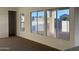Bright living room featuring multiple windows that provide natural light and backyard views at 10984 N 164Th Dr, Surprise, AZ 85388