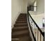 Staircase featuring carpeted steps and wrought iron railing at 10984 N 164Th Dr, Surprise, AZ 85388