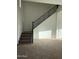 Staircase featuring iron railing and neutral carpeting at 10984 N 164Th Dr, Surprise, AZ 85388