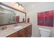Bathroom featuring granite countertops, wooden vanity, large mirror, and glass shower at 1146 E Rovey Ave, Phoenix, AZ 85014