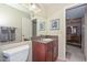 The bathroom features a granite vanity, a mirror and views to the dining room and living room at 1146 E Rovey Ave, Phoenix, AZ 85014