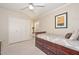 Bright bedroom featuring neutral walls, carpet, ceiling fan, and built-in under-bed storage drawers at 1146 E Rovey Ave, Phoenix, AZ 85014