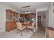 The dining room includes a glass cabinet, a wooden table with four chairs, and a view to the kitchen at 1146 E Rovey Ave, Phoenix, AZ 85014