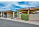 Townhouse exterior featuring covered parking, a secure front gate, and neatly landscaped surroundings at 1146 E Rovey Ave, Phoenix, AZ 85014