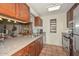 This kitchen features stone countertops, stainless steel appliances, wooden cabinets and tile flooring at 1146 E Rovey Ave, Phoenix, AZ 85014