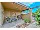 Covered patio with seating, grill, and decorative wall art, perfect for relaxing outdoors at 1146 E Rovey Ave, Phoenix, AZ 85014