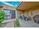 Cozy patio space perfect for outdoor dining, complete with a table, chairs, and ambient string lights at 1146 E Rovey Ave, Phoenix, AZ 85014