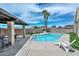 Beautiful pool area with palm trees, lounge chairs, and a covered seating space at 1146 E Rovey Ave, Phoenix, AZ 85014