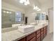Bathroom featuring dual sinks, granite counters, and a bright vanity area at 123 N Washington St # 16, Chandler, AZ 85225