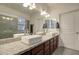 Bathroom featuring dual sinks, granite counters, and a bright vanity area at 123 N Washington St # 16, Chandler, AZ 85225